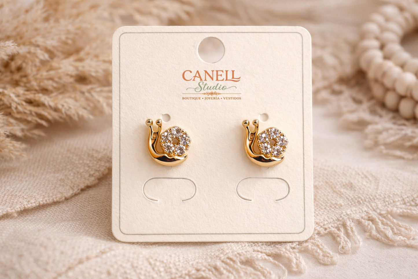 Arete Bañado en oro 18k Caracol con circones niña